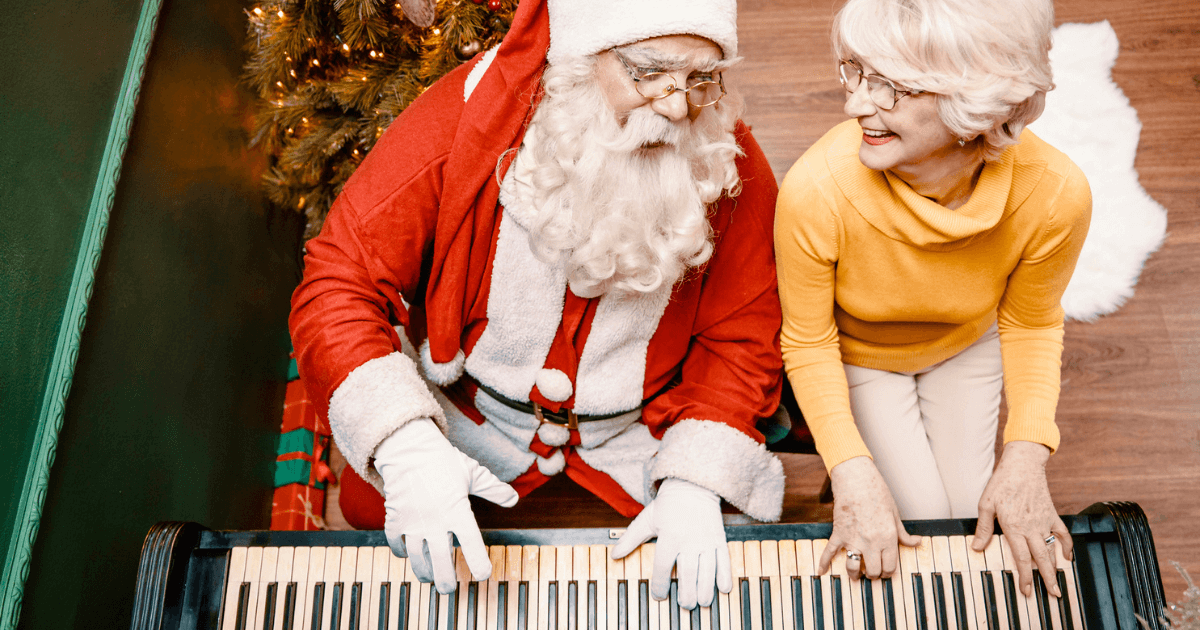 Santa Claus and elder woman playing piano